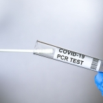 PCR test to COVID-19 in doctor hands, coronavirus swab collection kit close-up