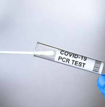 PCR test to COVID-19 in doctor hands, coronavirus swab collection kit close-up
