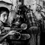 a boy working on a machine